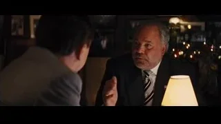 Two men conversing in dimly lit restaurant — The Wolf Of Wall Street