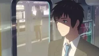 young man looking out train station window — Your Name
