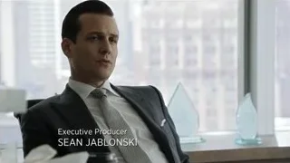 man in suit with awards by office window — Suits