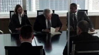 Four people in business attire at conference table — Suits