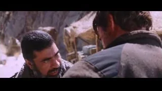two men conversing in rocky desert landscape — Iron Man