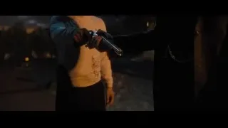 Person holding gun in dark alleyway — John Wick: Chapter 4