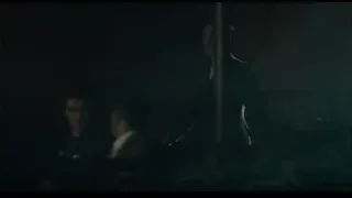man standing in dimly lit room — Peaky Blinders