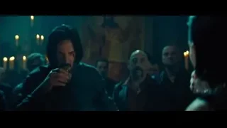 man holding whiskey in dark room — John Wick: Chapter 4