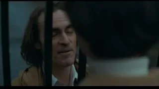 man smiling behind bars — Joker