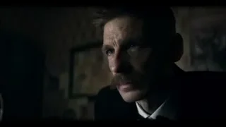 Man's face in dimly lit room with brick wall — Peaky Blinders
