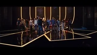 people standing on stage with yellow pattern — Now You See Me