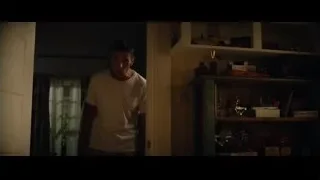 man in dimly lit room with bookshelf — Ford v Ferrari