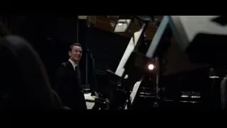 man in suit playing piano in dim room — Steve Jobs