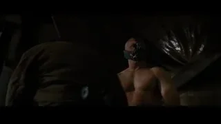 Person in dimly lit room with fire — Batman: The Dark Knight Rises