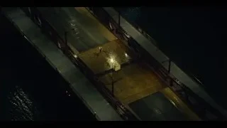 person walking on bridge at night — The Bear