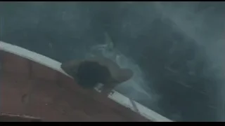 Person leaning over boat in choppy water — Life of Pi