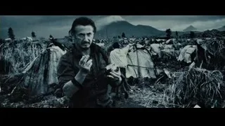 Man holding camera in field with mountain — The Secret Life of Walter Mitty
