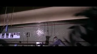 Person holding large snake in a room — Spider Man 2