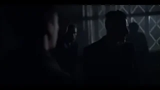 people in dimly lit room with geometric wall — Peaky Blinders