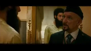 man in suit standing before mirror — The Dictator