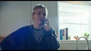 Young woman smiling in kitchen with rainbow light — The Bear