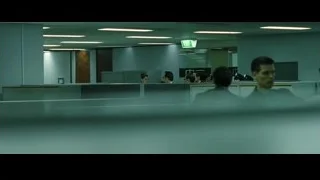 man sitting at desk in office cubicle — The Matrix