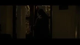 man and woman conversing in dim room — Batman: The Dark Knight Rises