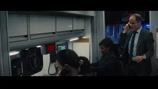 man in suit talking on phone in control room — Now You See Me