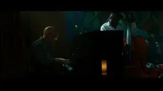 elderly man playing piano in dimly lit room — Whiplash