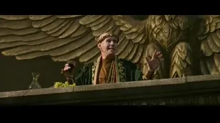 Man in crown on balcony with golden eagle — Gladiator 2