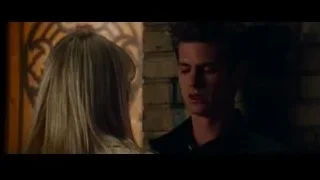 man and woman looking at each other in dim room — The Amazing Spider Man 2
