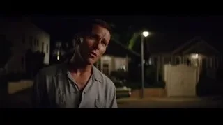 Man standing in dimly lit street at night — Ford v Ferrari