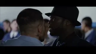 Two men in suits conversing tensely — Southpaw