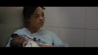 Woman holding baby with oxygen mask in hospital — Creed 2