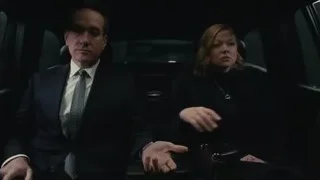 Man and woman looking out car window — Succession