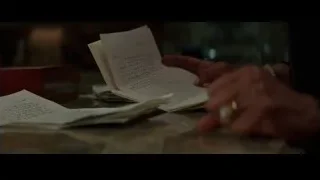 hand holding paper on wooden table — Creed 3