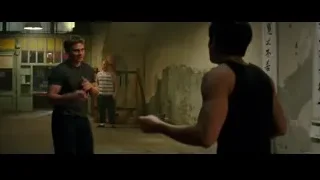 Man gesturing to another in dimly lit room — Bruce Lee: Birth of The Dragon