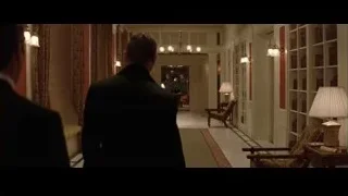 Two men walking in a long hallway — Batman