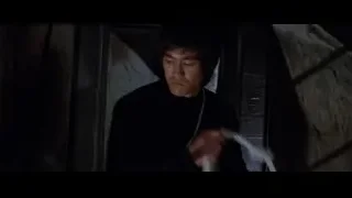 young man standing in dark room — Bruce Lee: Enter The Dragon