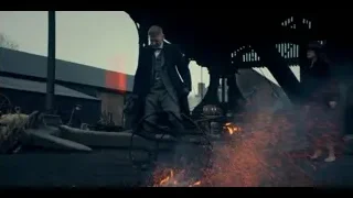 man in black coat by metal structure — Peaky Blinders