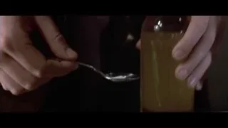 hand holding bottle with spoon — American Psycho