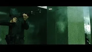 man in black suit and helmet holding gun — The Matrix