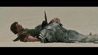 Armored man lying in desert with sword — Gladiator 2