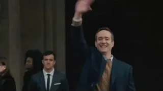 Man in suit waving and smiling — Succession