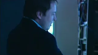 man in suit sitting at computer in dark room — Elon Musk: Return to Space