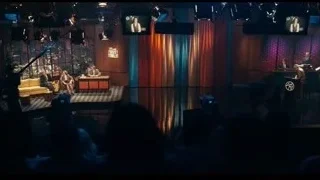 TV show stage with people at desk — Joker