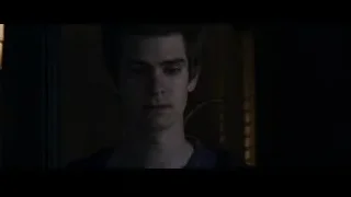 young man looking at camera in dim room — The Amazing Spider Man