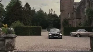 black Jaguar car parked at stone building — Succession