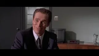 Man in suit sitting at office desk — American Psycho