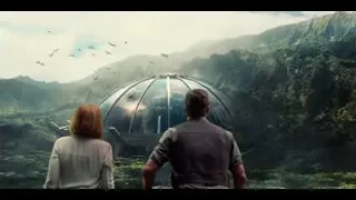 Man and woman by large dome in forest — Jurassic World