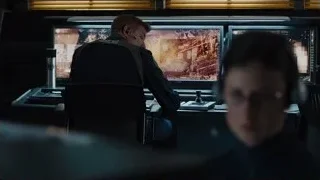 two men working at computer desks — The Avengers