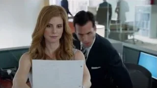 red-haired woman sitting at office desk — Suits