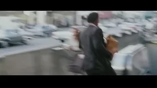 Man in suit walking on escalator — The Persuit of Happyness