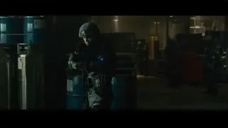 soldier holding rifle in dark warehouse — Furious Seven